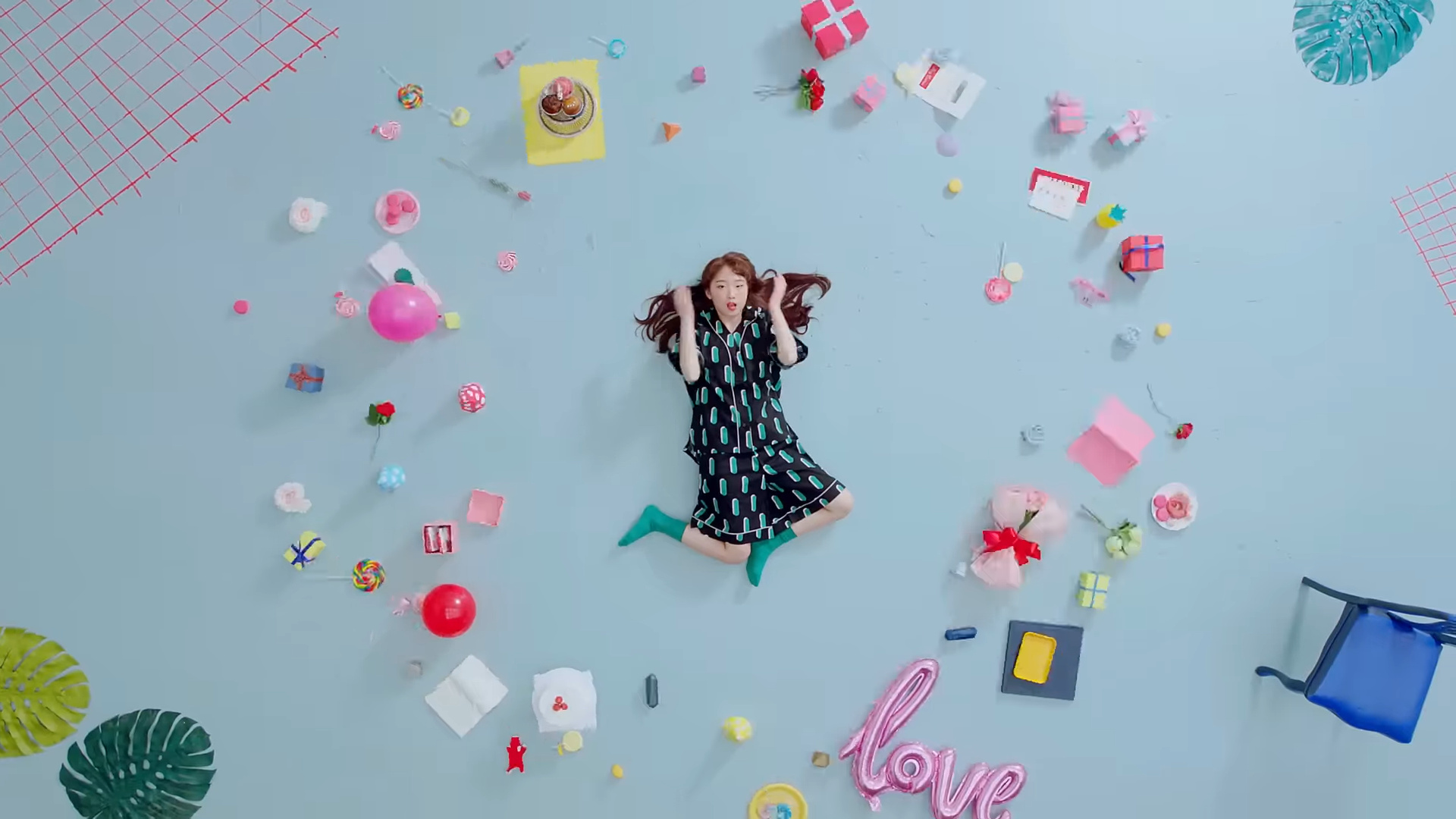 Yeojin laying on the floor, surrounded by various objects.